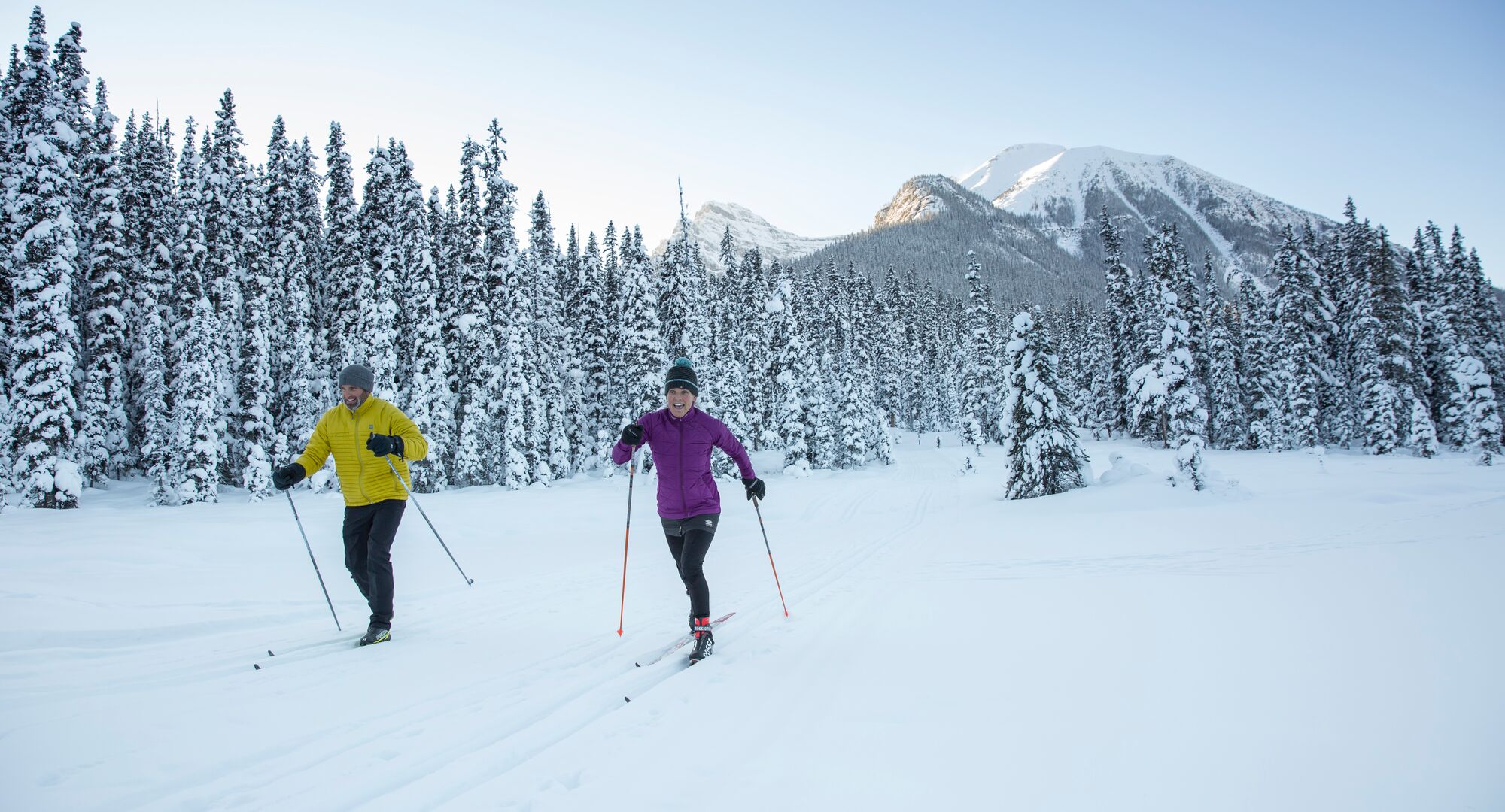 Two people having fun on cross country skis on the Great Divide Trail at Lake Louise